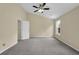 Spacious bedroom with neutral walls, plush carpeting, and ceiling fan at 2988 Belfaire Lake Dr, Dacula, GA 30019