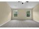 Carpeted bedroom with light walls and two large windows, offering plenty of natural light at 2988 Belfaire Lake Dr, Dacula, GA 30019