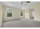 Light-filled bedroom with neutral walls, plush carpeting and vaulted ceiling at 2988 Belfaire Lake Dr, Dacula, GA 30019