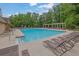 A large, inviting community pool surrounded by lounge chairs and lush greenery at 2988 Belfaire Lake Dr, Dacula, GA 30019