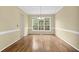 Spacious dining room bathed in natural light from large windows and wood flooring at 2988 Belfaire Lake Dr, Dacula, GA 30019