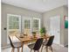 Cozy dining area with deck access, natural light, and stylish modern chairs at 2988 Belfaire Lake Dr, Dacula, GA 30019