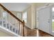Front entrance featuring a white front door, hardwood floors, and a staircase at 2988 Belfaire Lake Dr, Dacula, GA 30019