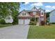 Charming brick home with a two-car garage, landscaped front yard, and inviting entrance at 2988 Belfaire Lake Dr, Dacula, GA 30019