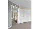 Hallway featuring multiple storage closets and an open doorway to a landing at 2988 Belfaire Lake Dr, Dacula, GA 30019
