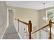 Hallway showing wooden banister and natural light at 2988 Belfaire Lake Dr, Dacula, GA 30019