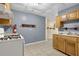 This kitchen features wooden cabinetry and a white gas range at 2988 Belfaire Lake Dr, Dacula, GA 30019