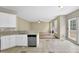 Eat-in kitchen featuring stainless steel appliances, granite counters, and a view into the home's living room at 2988 Belfaire Lake Dr, Dacula, GA 30019