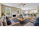 Open-concept living space with fireplace, hardwood floors, and seamless flow to dining area at 2988 Belfaire Lake Dr, Dacula, GA 30019