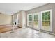 Bright living room boasts multiple windows, deck access, and a corner fireplace at 2988 Belfaire Lake Dr, Dacula, GA 30019