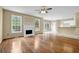 Bright open floor plan with fireplace, hardwood flooring, and access to the kitchen at 2988 Belfaire Lake Dr, Dacula, GA 30019