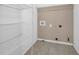 Storage room featuring shelving and tile flooring at 2988 Belfaire Lake Dr, Dacula, GA 30019