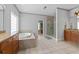 Elegant bathroom with a soaking tub, glass shower, and double vanity with granite countertops at 3519 Preserve Se Dr, Atlanta, GA 30339