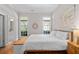 Bright bedroom featuring neutral walls, hardwood floors, natural light, and ensuite bathroom at 3519 Preserve Se Dr, Atlanta, GA 30339