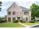 Charming two-story brick home with manicured lawn, dark shutters, and inviting entryway at 3519 Preserve Se Dr, Atlanta, GA 30339