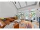 Comfortable living room with vaulted ceiling, a cozy leather sofa, and bright French doors at 3519 Preserve Se Dr, Atlanta, GA 30339