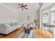 Cozy living room with hardwood floors, large windows, and a stylish rug and furniture at 3519 Preserve Se Dr, Atlanta, GA 30339