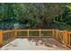 Wooden deck with a wooden railing offering a view of the backyard with lush greenery and mature trees at 51 Ivy Chase Ne, Atlanta, GA 30342