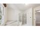 Bathroom featuring a soaking tub with jets and a separate glass-enclosed shower at 51 Ivy Chase Ne, Atlanta, GA 30342