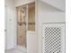 Bathroom featuring a glass-enclosed shower with tiled walls and a storage area with a lattice door at 51 Ivy Chase Ne, Atlanta, GA 30342