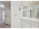 Bathroom featuring white cabinetry with a large vanity, makeup mirror and access to shower at 51 Ivy Chase Ne, Atlanta, GA 30342