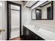 Bathroom featuring black trim, detailed wallpaper, and large vanity at 51 Ivy Chase Ne, Atlanta, GA 30342