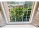 Scenic view from a charming bay window overlooking lush greenery and a neighboring brick home at 51 Ivy Chase Ne, Atlanta, GA 30342