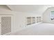 Bright bonus room featuring a vaulted ceiling, carpeted floor and built-in shelving for ample storage at 51 Ivy Chase Ne, Atlanta, GA 30342