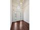 Bright foyer featuring hardwood floors, a decorative light fixture, and a stylish front door at 51 Ivy Chase Ne, Atlanta, GA 30342