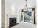 Cozy room with fireplace and chandelier, with an access door to an outdoor space at 51 Ivy Chase Ne, Atlanta, GA 30342