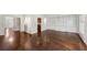 Spacious room featuring hardwood floors, a window, custom built in shelving, and view to other rooms at 51 Ivy Chase Ne, Atlanta, GA 30342