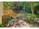 Brick patio features outdoor seating, a stone bench, and lush landscaping, perfect for enjoying the backyard at 51 Ivy Chase Ne, Atlanta, GA 30342