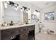 Bright bathroom with double vanity, granite countertop, modern lighting, and a window for natural light at 7994 Devonshire Dr, Jonesboro, GA 30238