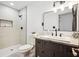 Modern bathroom features walk-in shower, granite countertop, and dark-stained vanity at 7994 Devonshire Dr, Jonesboro, GA 30238