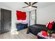 Bedroom showcasing dark furniture, ceiling fan, and unique wall decor at 7994 Devonshire Dr, Jonesboro, GA 30238