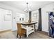 Charming kitchen with modern lighting, stainless appliances, and a cozy breakfast nook with wicker chair at 7994 Devonshire Dr, Jonesboro, GA 30238