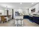 Well-lit kitchen with island seating, stainless appliances, and modern cabinetry at 7994 Devonshire Dr, Jonesboro, GA 30238