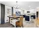 Open kitchen with granite countertops, modern appliances, and dining area with stylish furniture at 7994 Devonshire Dr, Jonesboro, GA 30238