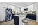 Modern kitchen with white upper cabinets, navy blue lower cabinets, and a center island at 7994 Devonshire Dr, Jonesboro, GA 30238