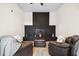 Inviting living room featuring a painted brick fireplace, plush seating, and a cozy ambiance at 7994 Devonshire Dr, Jonesboro, GA 30238