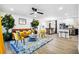 Open-concept living room with view of kitchen, modern furniture, and stylish accents at 7994 Devonshire Dr, Jonesboro, GA 30238
