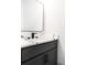Stylish powder room featuring a floating vanity with quartz countertop and modern fixtures at 110 Northwood Creek Way, Oxford, GA 30054