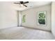 Bright bedroom features new carpet, ceiling fan, and double windows letting in natural light at 110 Northwood Creek Way, Oxford, GA 30054