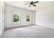 Bright bedroom features new carpet, ceiling fan, and double windows letting in natural light at 110 Northwood Creek Way, Oxford, GA 30054