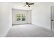 Bright bedroom features new carpet, ceiling fan, and double windows letting in natural light at 110 Northwood Creek Way, Oxford, GA 30054