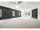 Large bedroom with an electric fireplace, media center, and modern wainscoting at 110 Northwood Creek Way, Oxford, GA 30054