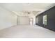Spacious bedroom boasts a tray ceiling, modern wainscoting, and carpet flooring at 110 Northwood Creek Way, Oxford, GA 30054