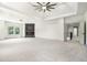 Large bonus room with an electric fireplace, media center, tray ceiling, and access to bathroom and bedroom at 110 Northwood Creek Way, Oxford, GA 30054