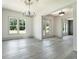 Dining room filled with natural light showcasing floors and elegant chandelier at 110 Northwood Creek Way, Oxford, GA 30054