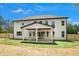 Back exterior of home with covered patio, white siding, dark trim, and a fenced backyard at 110 Northwood Creek Way, Oxford, GA 30054